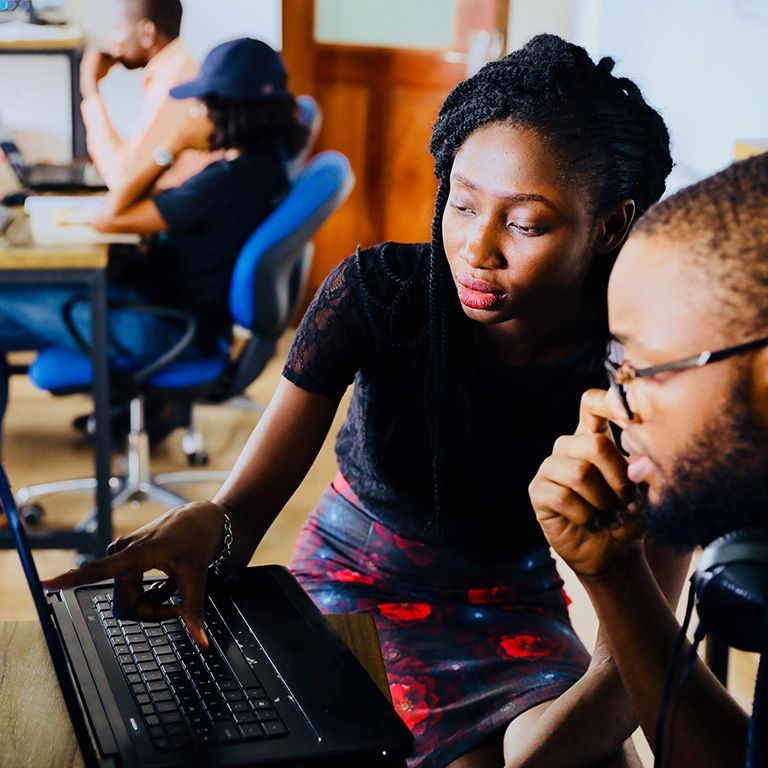 Male and Female students at table working