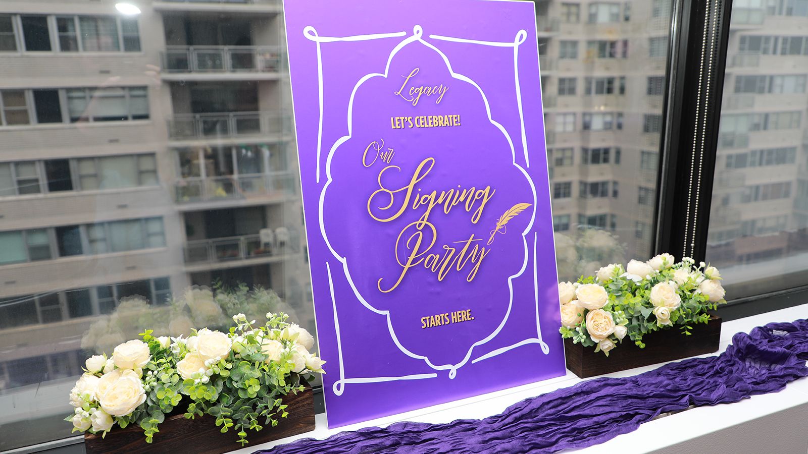 Sign on a window ledge that reads "Will signing Party"