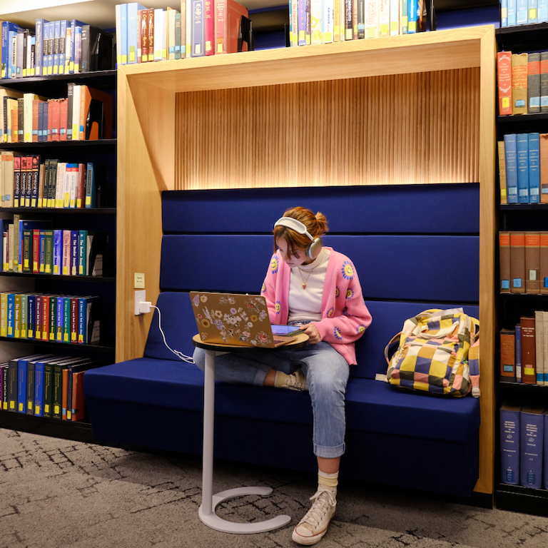 Student working at laptop in health professions library