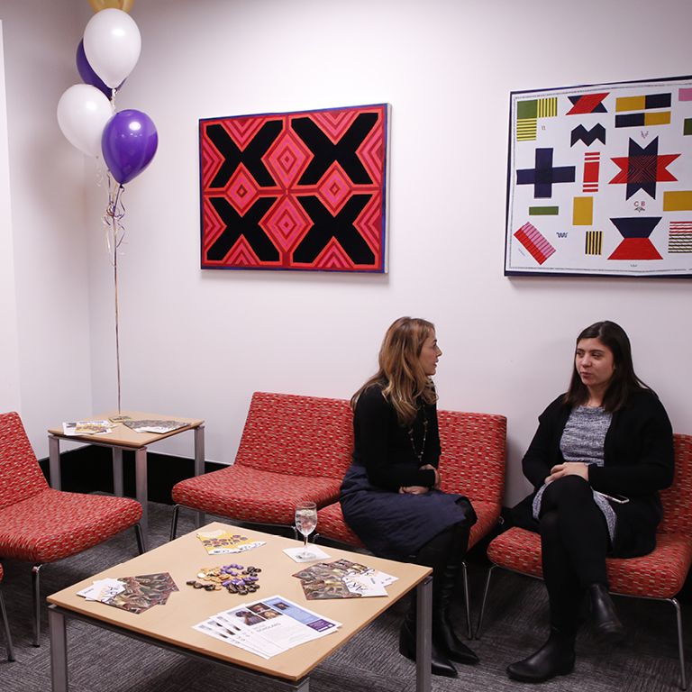 Two students talking while sitting in the Zankel Arts Hub.